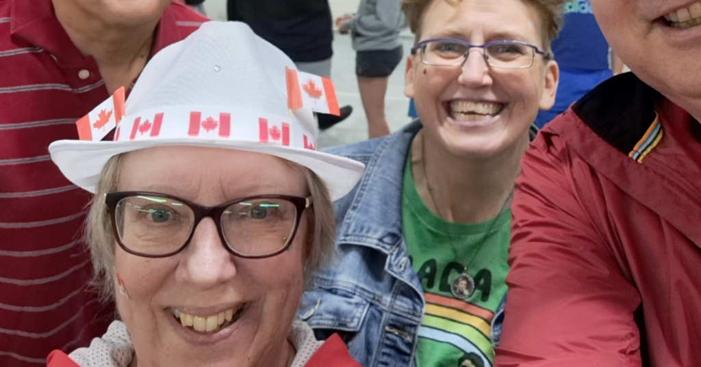 Carman Wellness Connections volunteers smiling together while celebrating Canada Day at a community event.